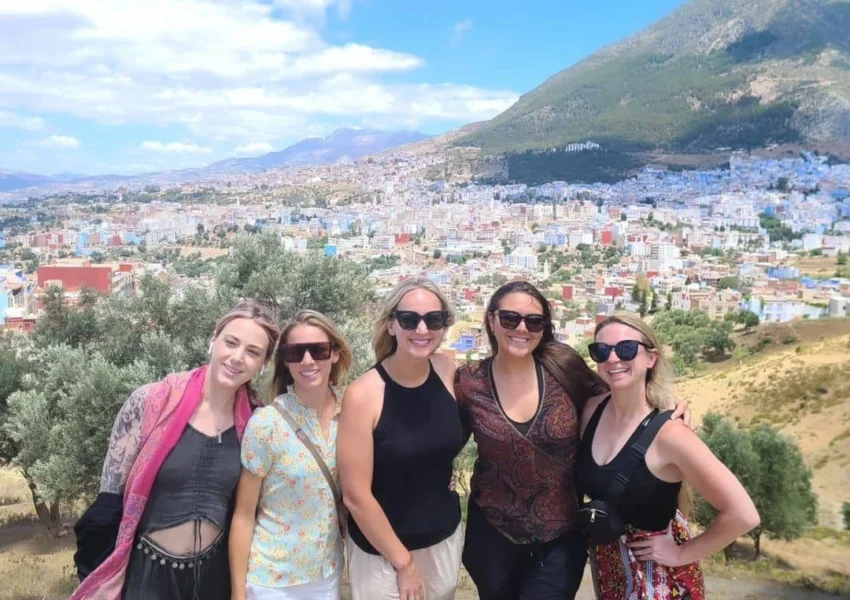 Women exploring the blue streets of Chefchaouen on a day trip from Rabat.